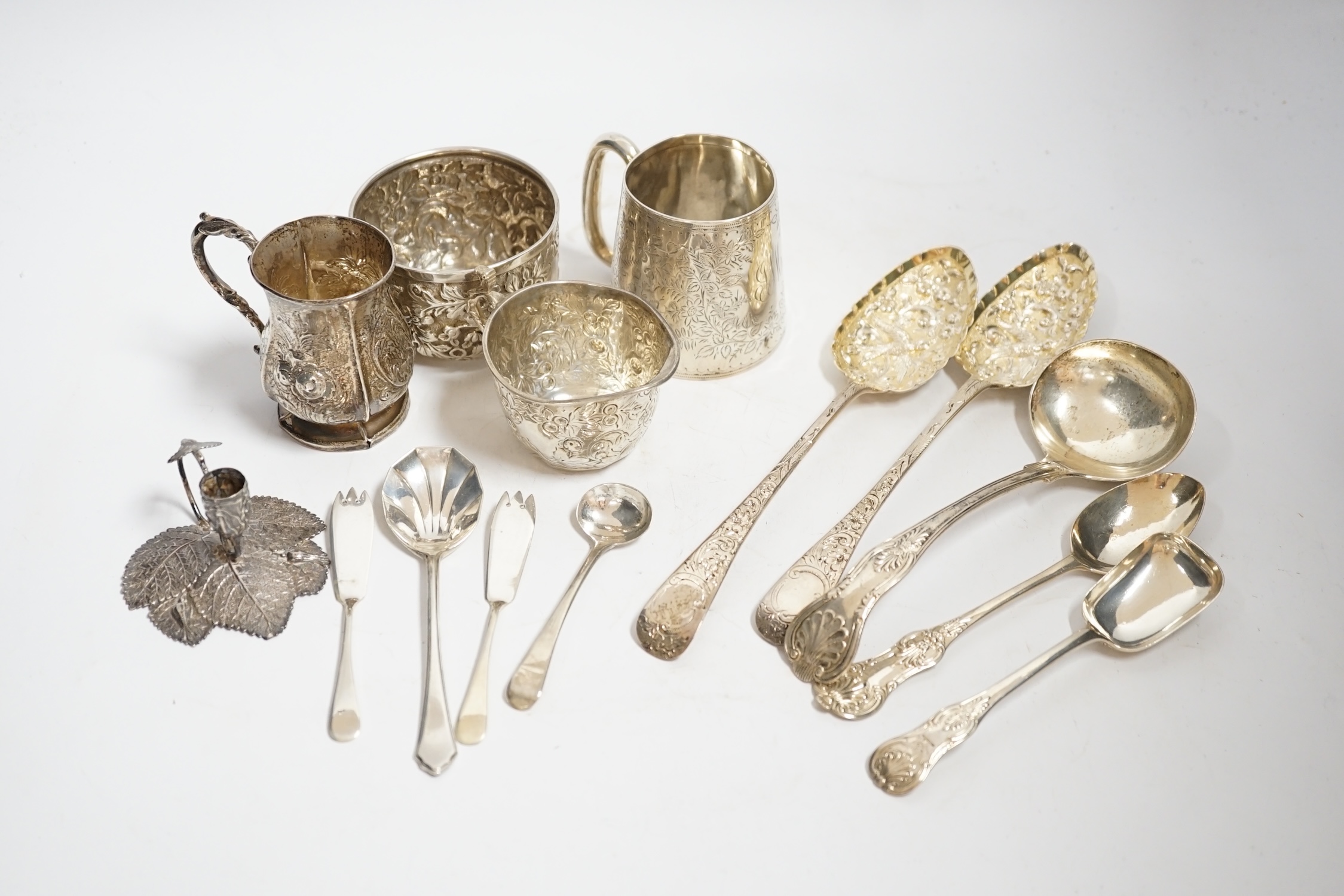 Two Victorian silver christening mugs, tallest 75mm, a Victorian silver cream jug and sugar bowl, a William IV silver leaf chamberstick by Taylor & Perry, Birmingham, 1830 and nine assorted items of silver flatware inclu